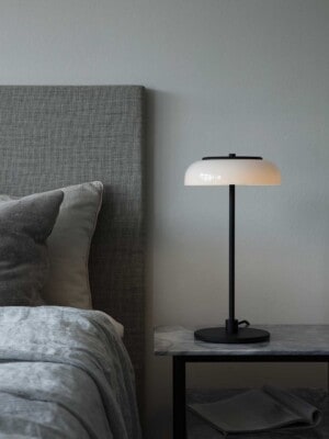Настольная лампа Nuura Blossi Table черного цвета в интерьере спальни