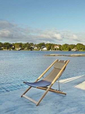 Дизайнерсоке кресло-шезлонг для отдыха Skargaarden H55 на террасе с видом на воду